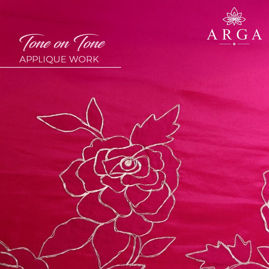 A close-up of a bright pink fabric with tonal floral applique embroidery in a lighter pink or white thread. The text 'Tone on Tone APPLIQUE WORK' appears on the top left, and the brand name 'ARGA' with a floral logo is on the top right.